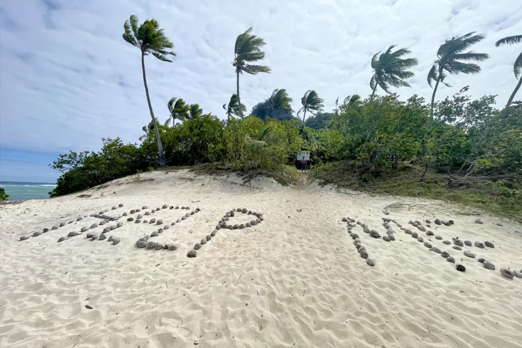 Help Me sign assembled by rocks at Monuriki Island.